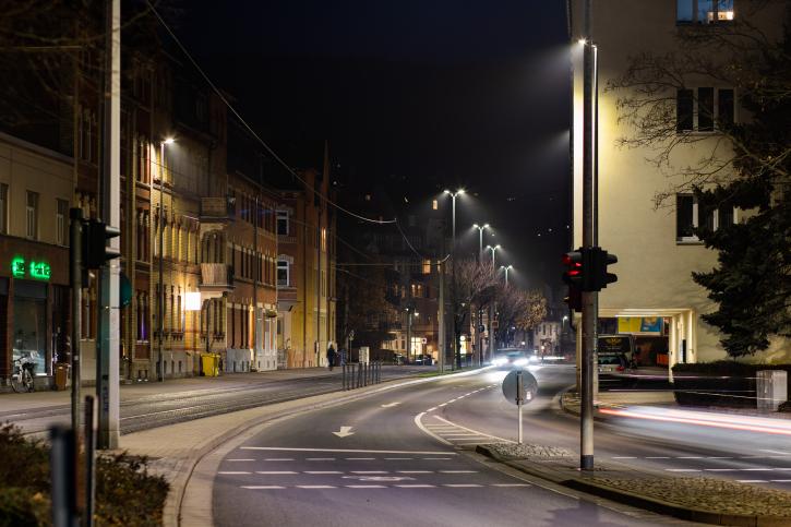 Street illuminated at night with pedestrian paths